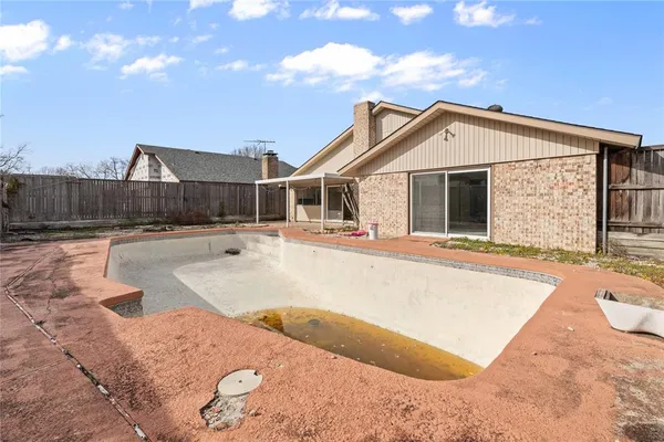 a view of a house with swimming pool and sitting area