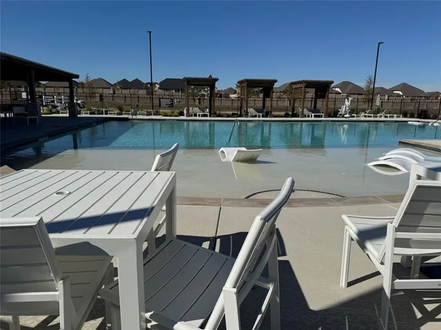 a view of a street with houses in the background