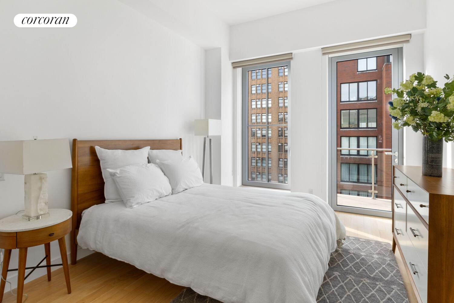 83 Walker Street, Unit 4 Manhattan, NY 10013 - Photo 12 of 21 a large bed sitting in a bedroom next to a window