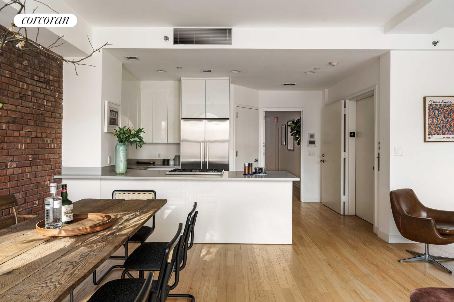 83 Walker Street, Unit 4 Manhattan, NY 10013 - Photo 8 of 21 a large kitchen with kitchen island a large counter top space a sink stainless steel appliances and cabinets