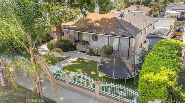aerial view of a house with a yard fountain and large tree