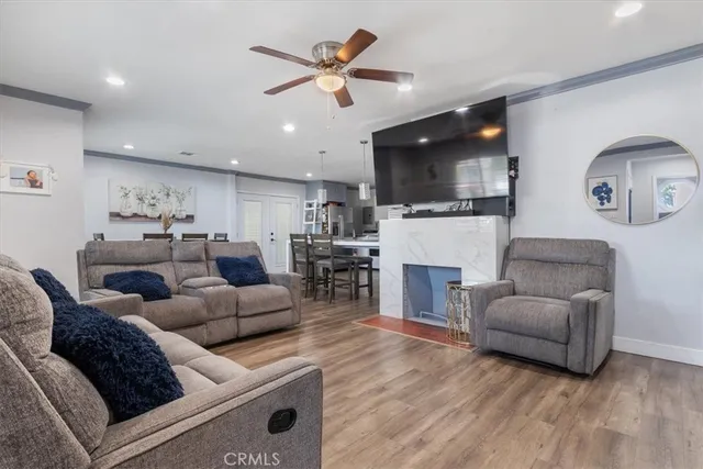 a living room with furniture a fireplace and a flat screen tv