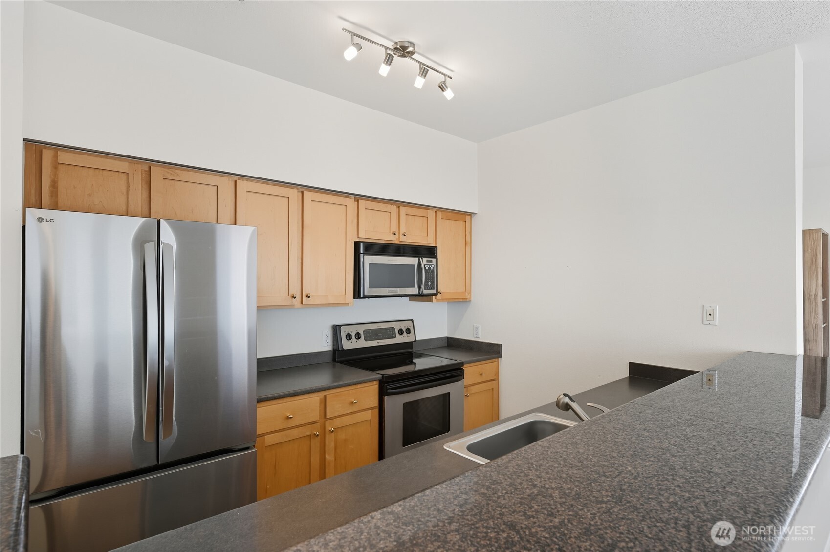 303 23rd Avenue South, Unit 602 Seattle, WA 98144 - Photo 11 of 26 a kitchen with a refrigerator stove and microwave