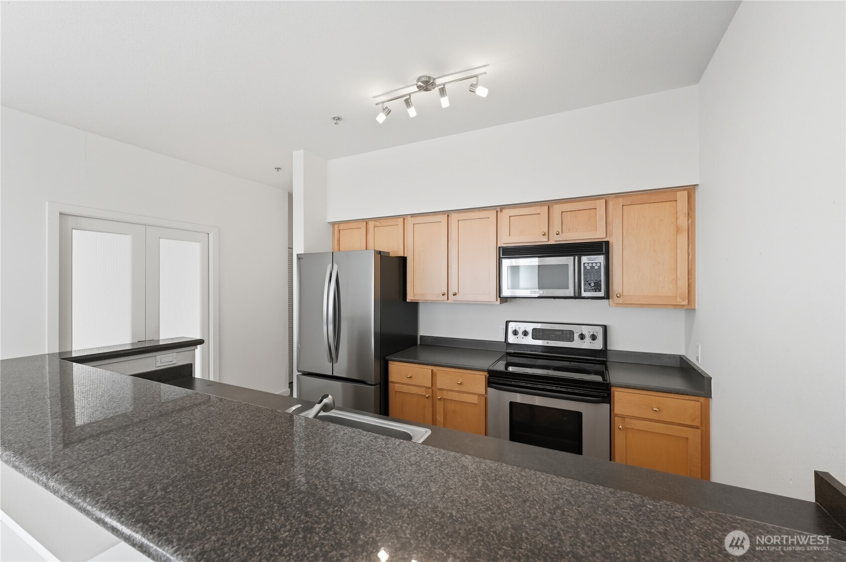 303 23rd Avenue South, Unit 602 Seattle, WA 98144 - Photo 12 of 26 a kitchen with stainless steel appliances a refrigerator stove and microwave