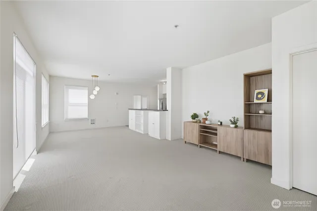 a view of a kitchen with furniture and white cabinets