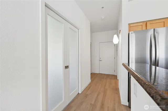 a view of a hallway with wooden floor and staircase