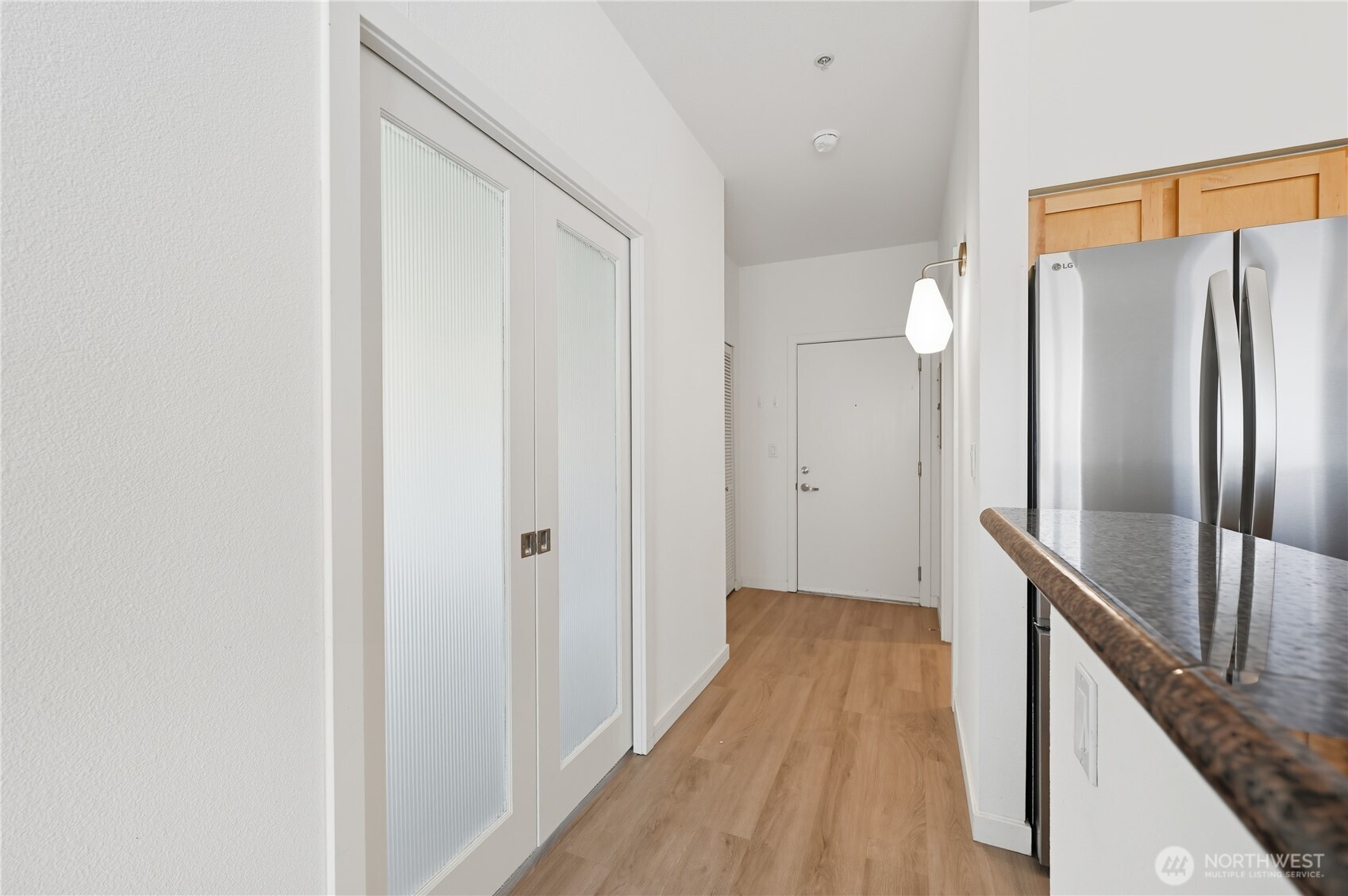 303 23rd Avenue South, Unit 602 Seattle, WA 98144 - Photo 9 of 26 a view of a hallway with wooden floor and staircase