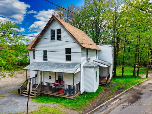 a view of house with a yard and furniture