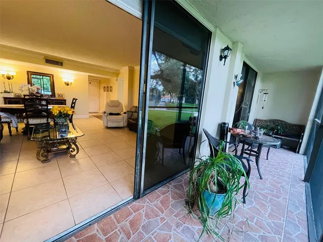 a building outdoor space with patio furniture and potted plants