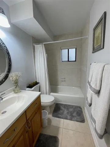 a bathroom with a sink a toilet and bathtub