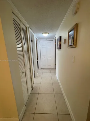 a view of a hallway to rooms