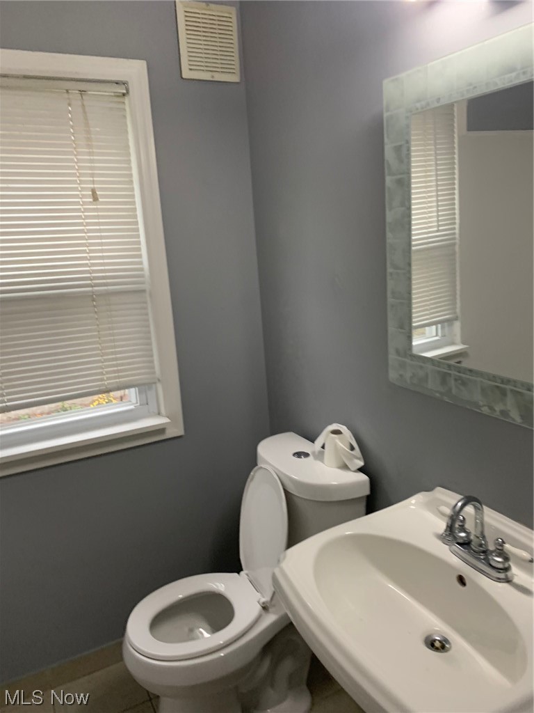 1287 Churchill Road Lyndhurst, OH 44124 - Photo 11 of 27 Bathroom with tile floors, toilet, and sink on main floor