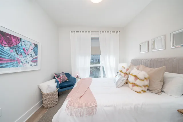 a bedroom with a bed and a painting on the wall