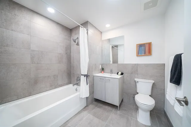 a bathroom with a toilet a sink and bathtub