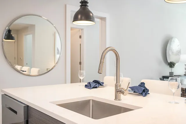 a kitchen with a sink and a mirror