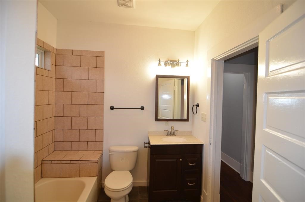 1905 Stevens Street, Unit 2 Houston, TX 77026 - Photo 16 of 22 a bathroom with a toilet a sink and mirror