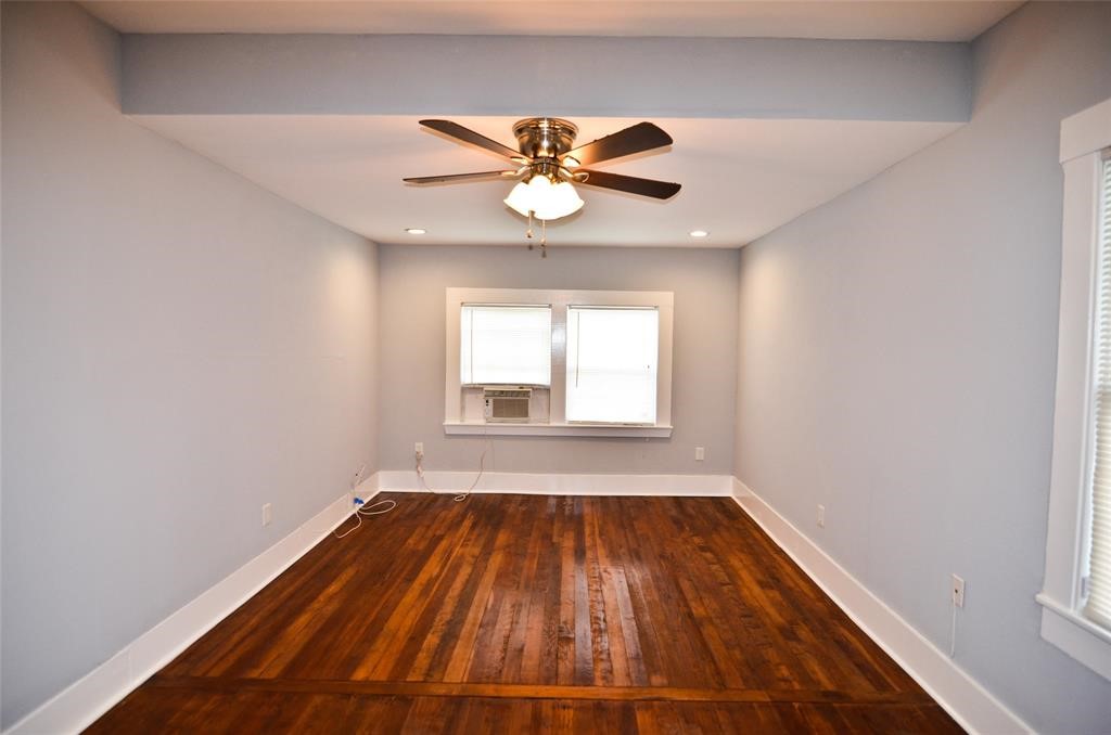 1905 Stevens Street, Unit 2 Houston, TX 77026 - Photo 2 of 22 a view of an empty room with wooden floor and a window