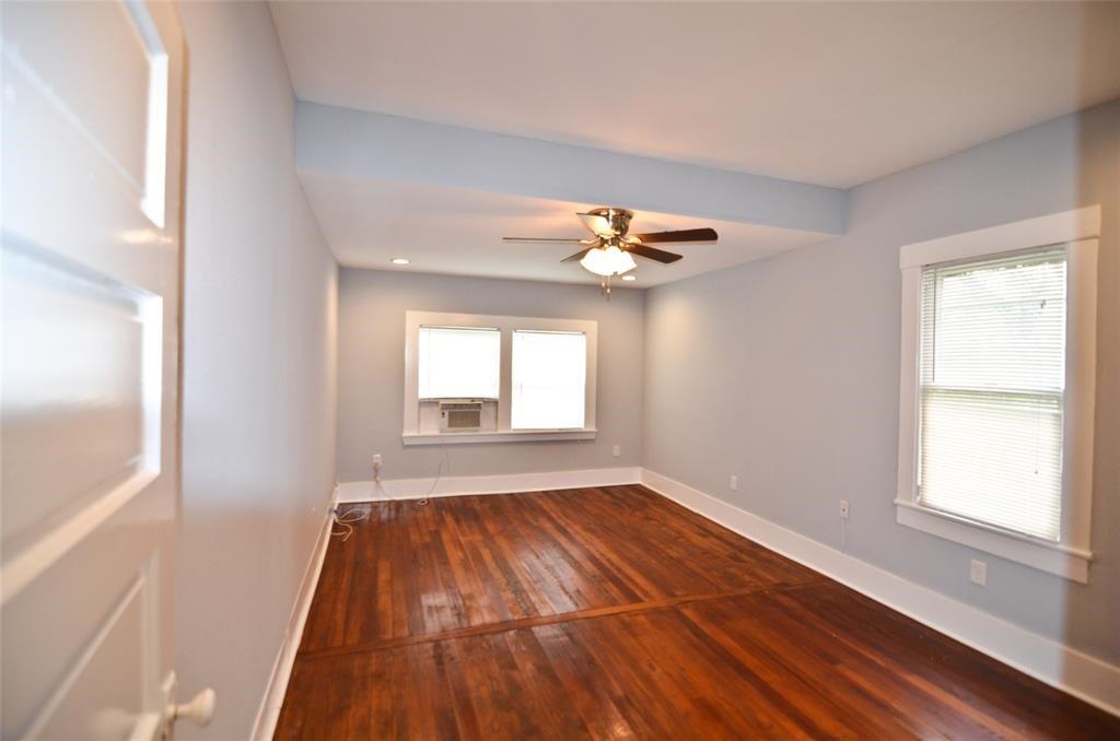 1905 Stevens Street, Unit 2 Houston, TX 77026 - Photo 4 of 22 a view of an empty room with wooden floor and a window