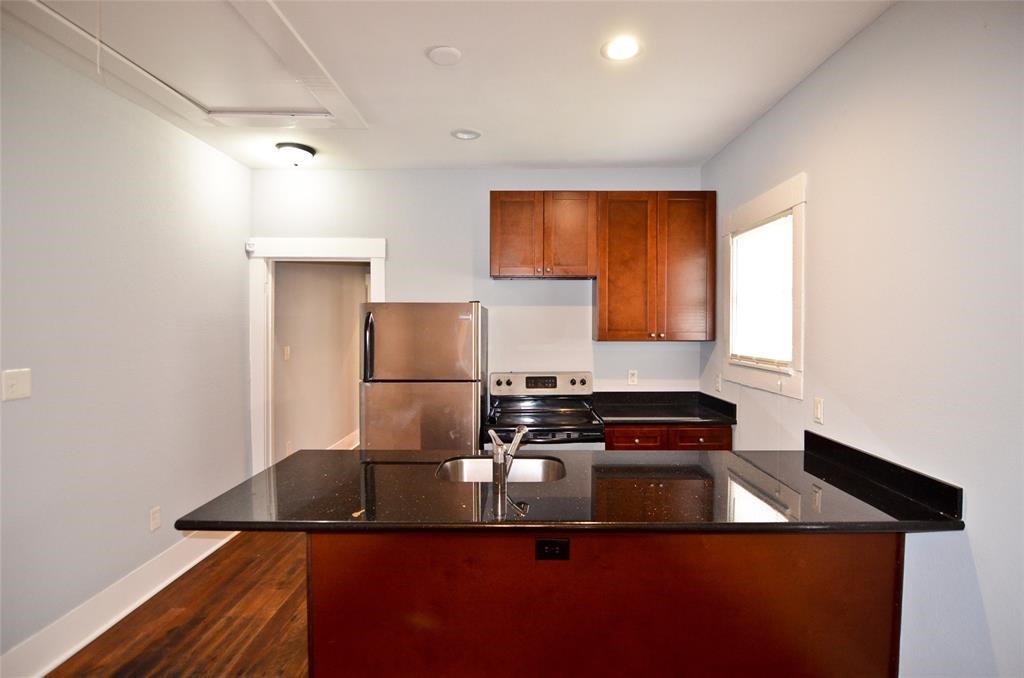 1905 Stevens Street, Unit 2 Houston, TX 77026 - Photo 8 of 22 a kitchen with a sink a counter top space and cabinets