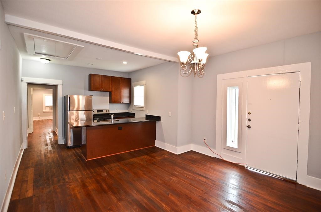 1905 Stevens Street, Unit 2 Houston, TX 77026 - Photo 9 of 22 a view of a kitchen with granite countertop wooden floor stainless steel appliances and a chandelier