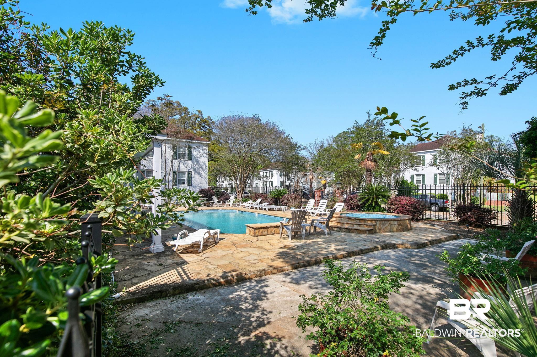 214 Upham Street, Unit 8D Mobile, AL 36607 - Photo 34 of 36 View of swimming pool featuring patio surround and a jacuzzi