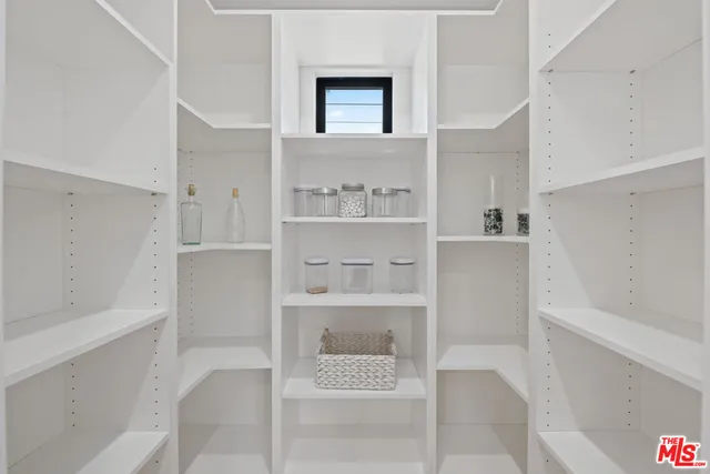 a spacious bedroom with a large bed and a dresser