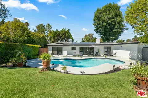 a front view of house with yard and outdoor seating