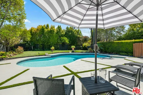 a view of a chairs and table in the patio with a fire pit
