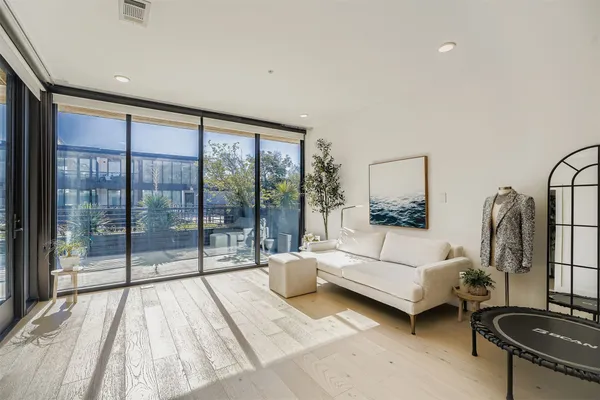 a living room with furniture and a floor to ceiling window