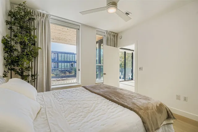 a bedroom with a large bed and a window