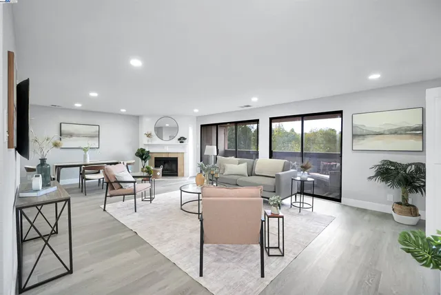 a living room with furniture a mirror and a fireplace
