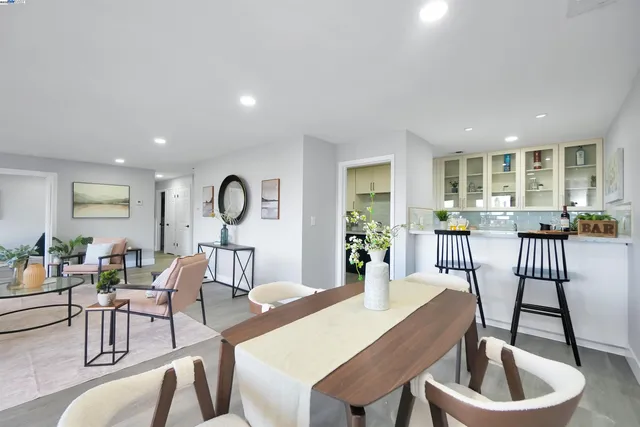 a living room with furniture a fireplace and a table