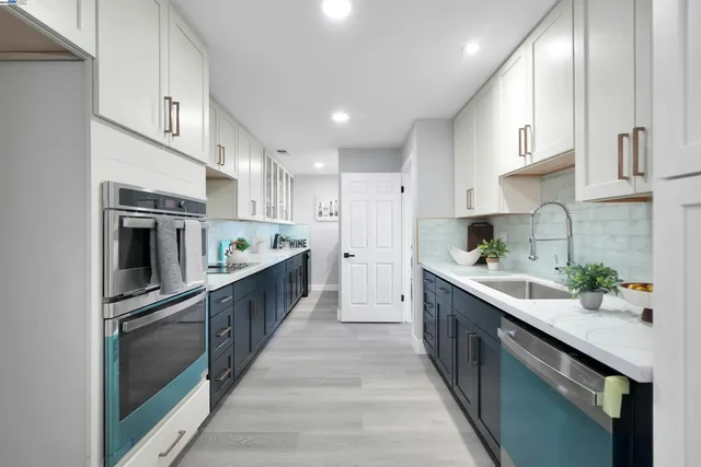 a kitchen with stainless steel appliances granite countertop a sink and cabinets