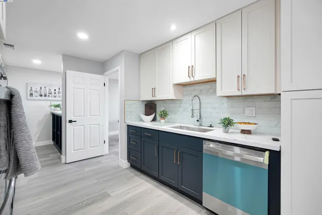 a kitchen with a sink stove and cabinets