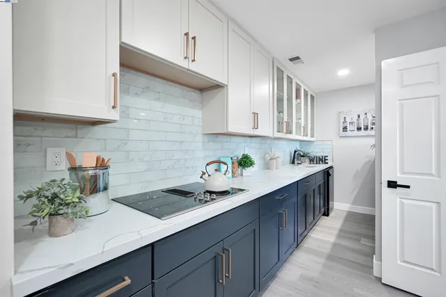 a kitchen with stainless steel appliances a sink stove and cabinets