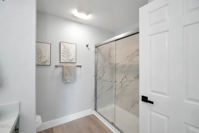 a bedroom with a large bed and a potted plant