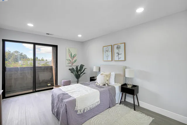 a spacious bedroom with a bed and a couch