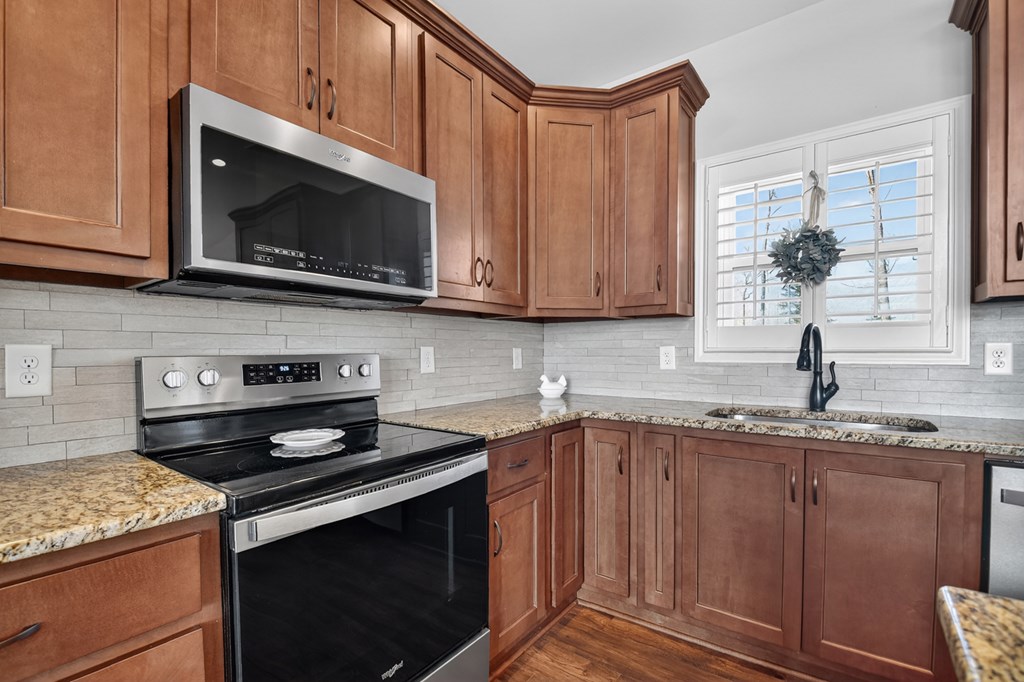 28 Mountaintown Road Ellijay, GA 30540 - Photo 17 of 54 a kitchen with stainless steel appliances granite countertop a sink stove and microwave