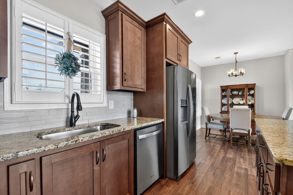28 Mountaintown Road Ellijay, GA 30540 - Photo 18 of 54 a kitchen with stainless steel appliances granite countertop a refrigerator a sink dishwasher a stove and a dining table with wooden floor