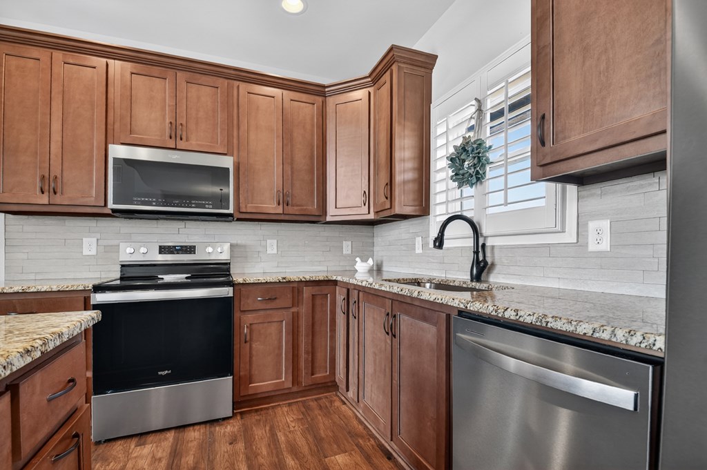 28 Mountaintown Road Ellijay, GA 30540 - Photo 19 of 54 a kitchen with granite countertop wooden cabinets and stainless steel appliances