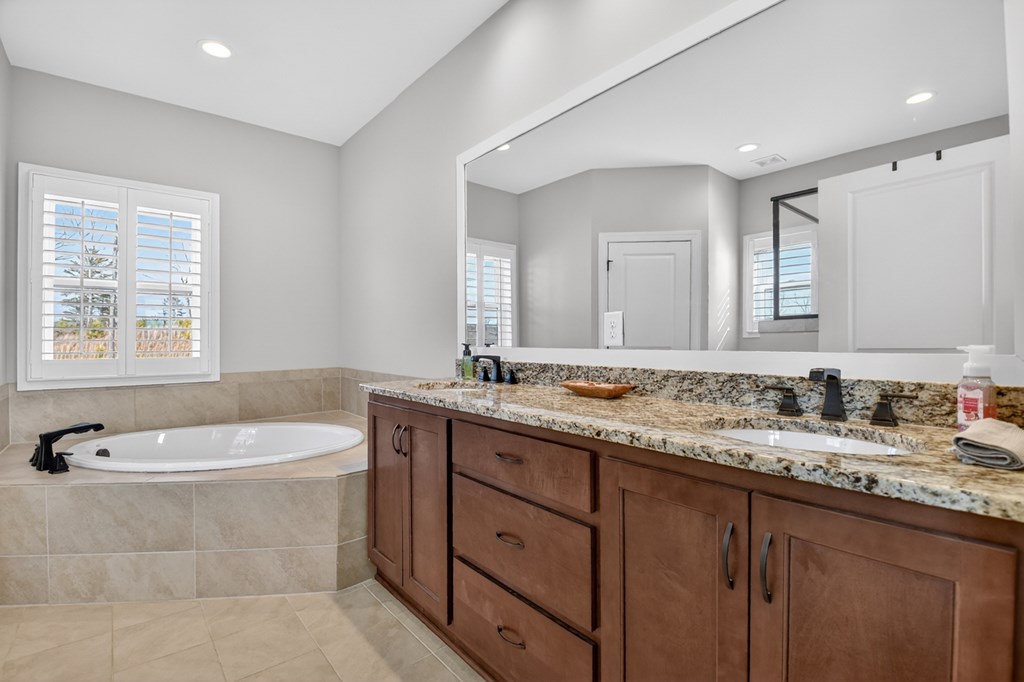 28 Mountaintown Road Ellijay, GA 30540 - Photo 22 of 54 a bathroom with a granite countertop sink a large mirror and a bathtub