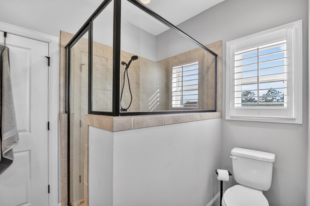 28 Mountaintown Road Ellijay, GA 30540 - Photo 25 of 54 a bathroom with a toilet sink a mirror and a window