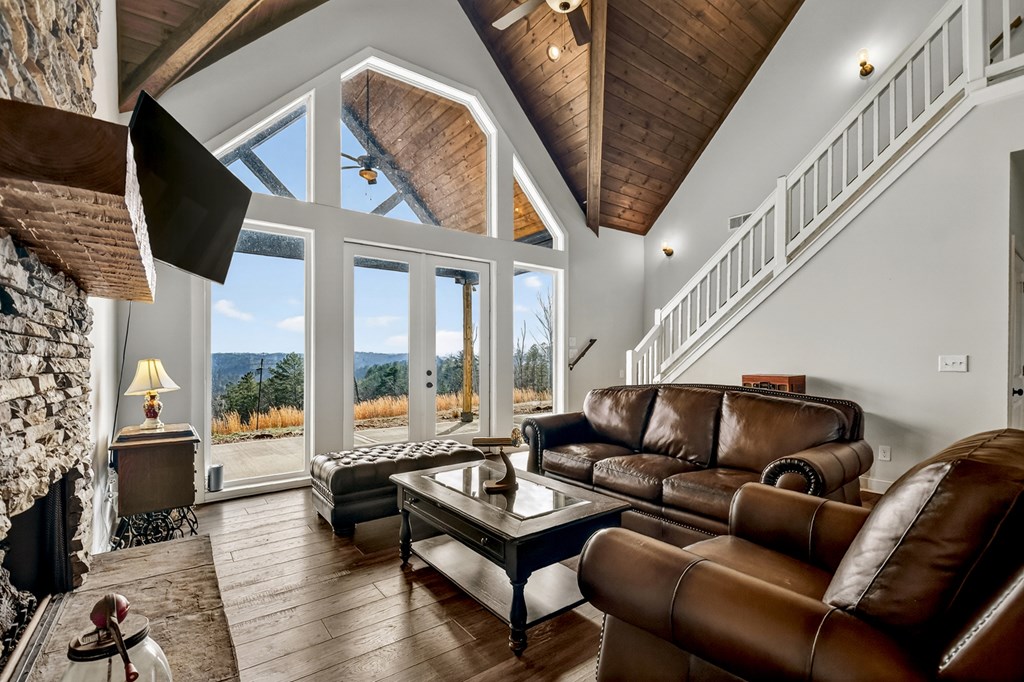 28 Mountaintown Road Ellijay, GA 30540 - Photo 10 of 54 a living room with furniture a fireplace and a floor to ceiling window