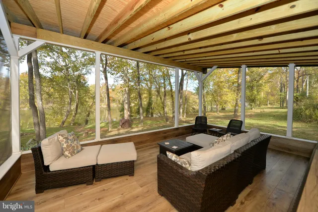 a living room with furniture and a floor to ceiling window