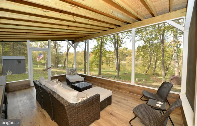 a living room with furniture and floor to ceiling windows