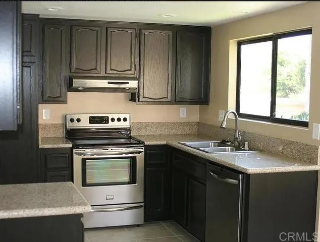 a kitchen with a stove microwave and sink