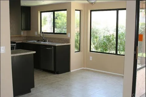 a kitchen with a sink and large window