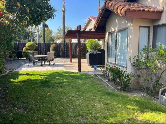 a view of a backyard with a patio and a garden