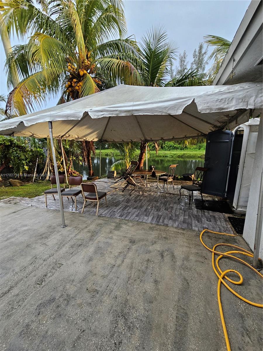 Westview Miami, FL 33167 - Photo 11 of 46 a view of a patio with a table and chairs under an umbrella