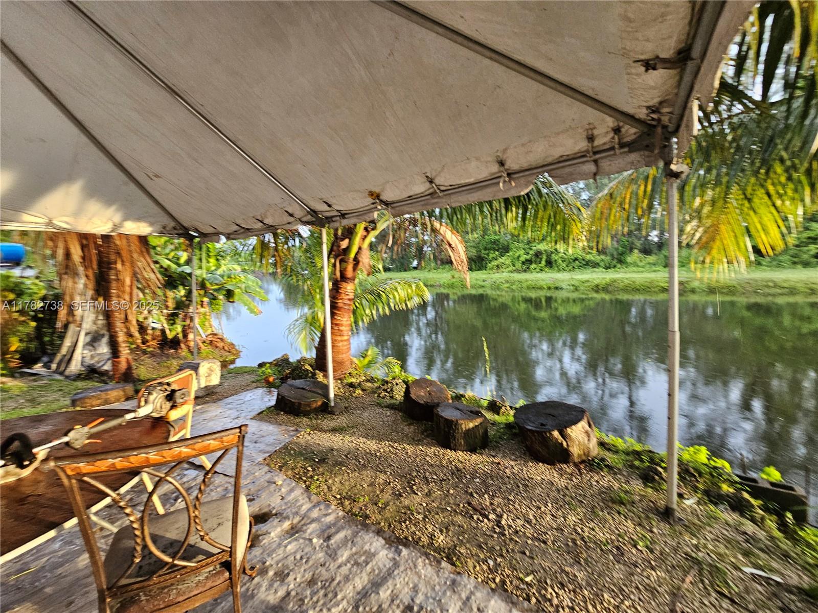 Westview Miami, FL 33167 - Photo 13 of 46 a backyard of a house with a fountain swing table and chairs